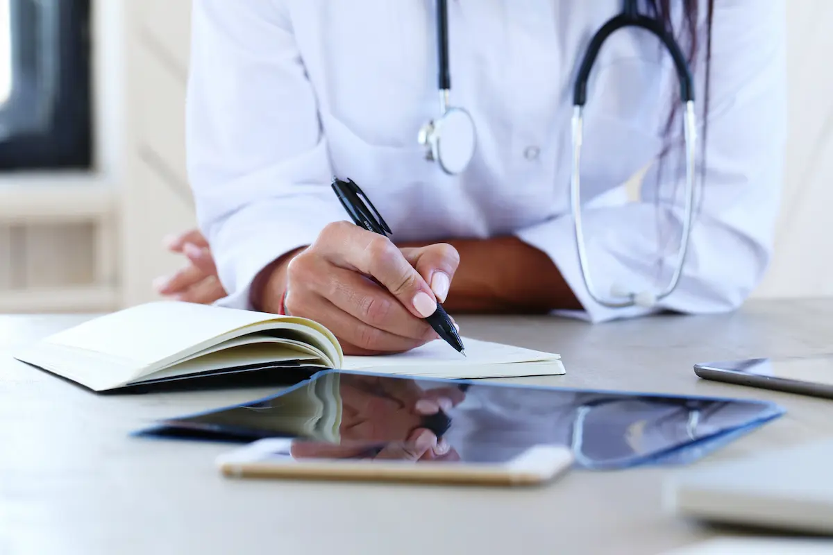 médico realizando anotações